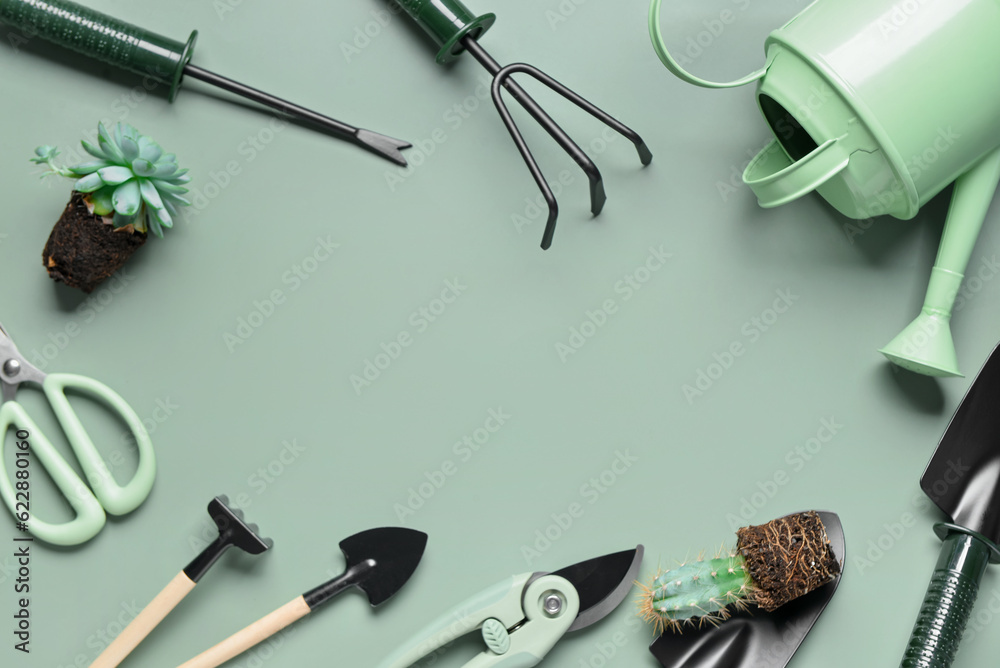 Frame made of different gardening tools on green background