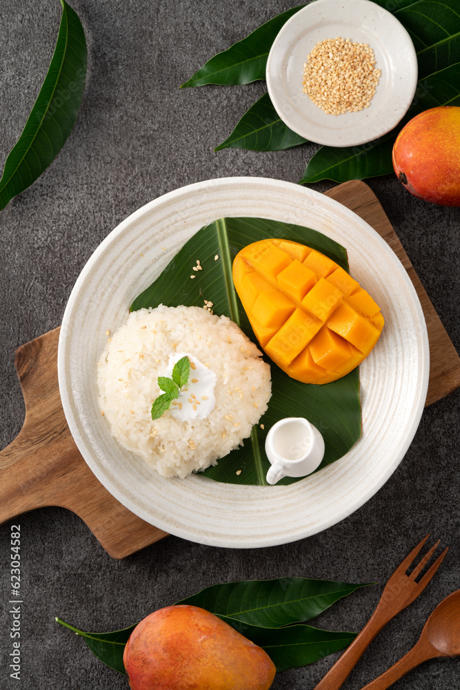 Delicious Thai mango sticky rice with cut fresh mango fruit in a plate.