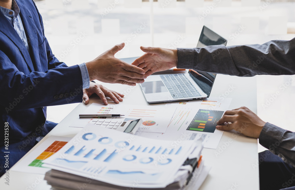 Business people shaking hands in a successful financial and investment cooperation meeting.