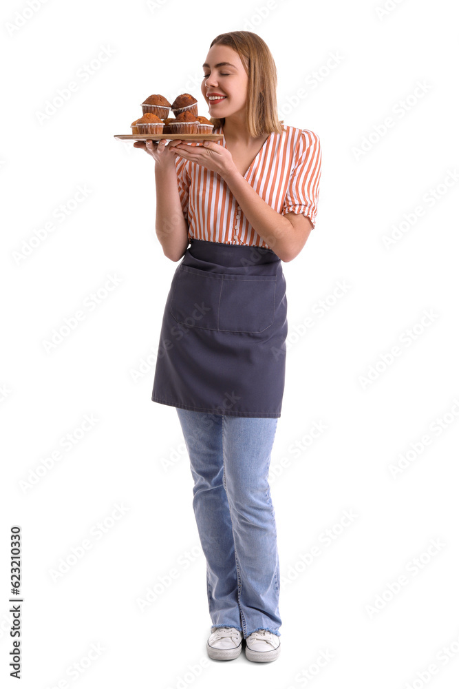 Female baker with tray of tasty cupcakes on white background