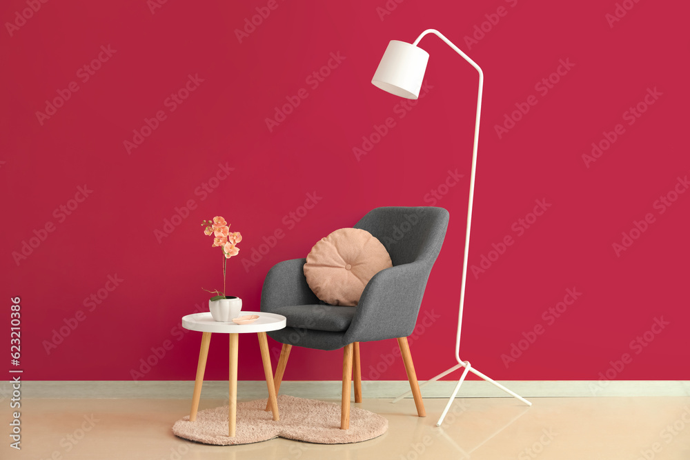 Interior of stylish living room with black armchair, table and standard lamp