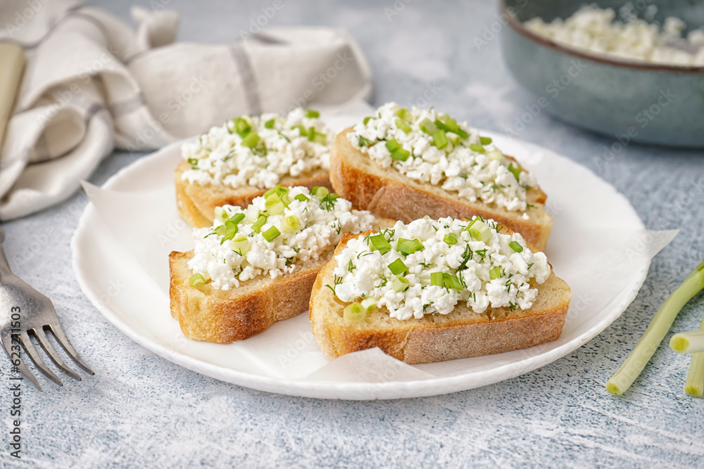 Sandwiches with tasty cottage cheese and green onion on grey background