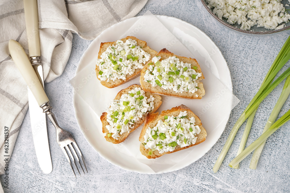 Sandwiches with tasty cottage cheese and green onion on grey background