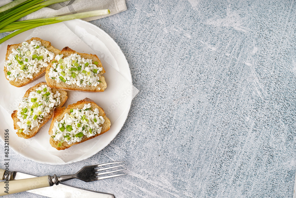 Sandwiches with tasty cottage cheese and green onion on grey background