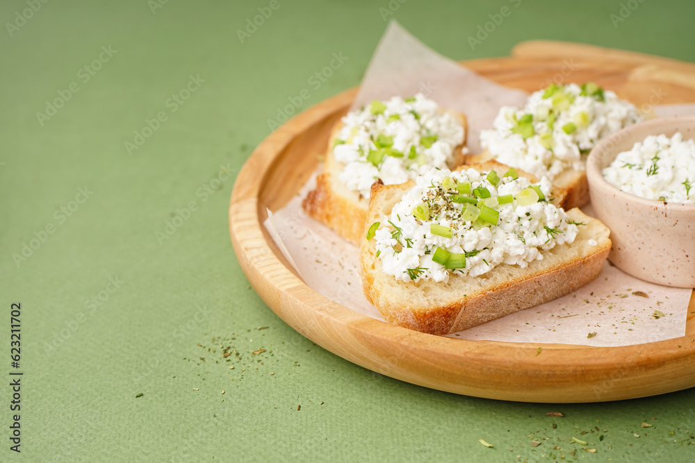 Sandwiches with tasty cottage cheese and green onion on color background