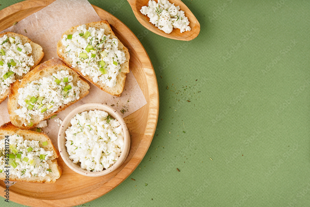 Sandwiches with tasty cottage cheese and green onion on color background