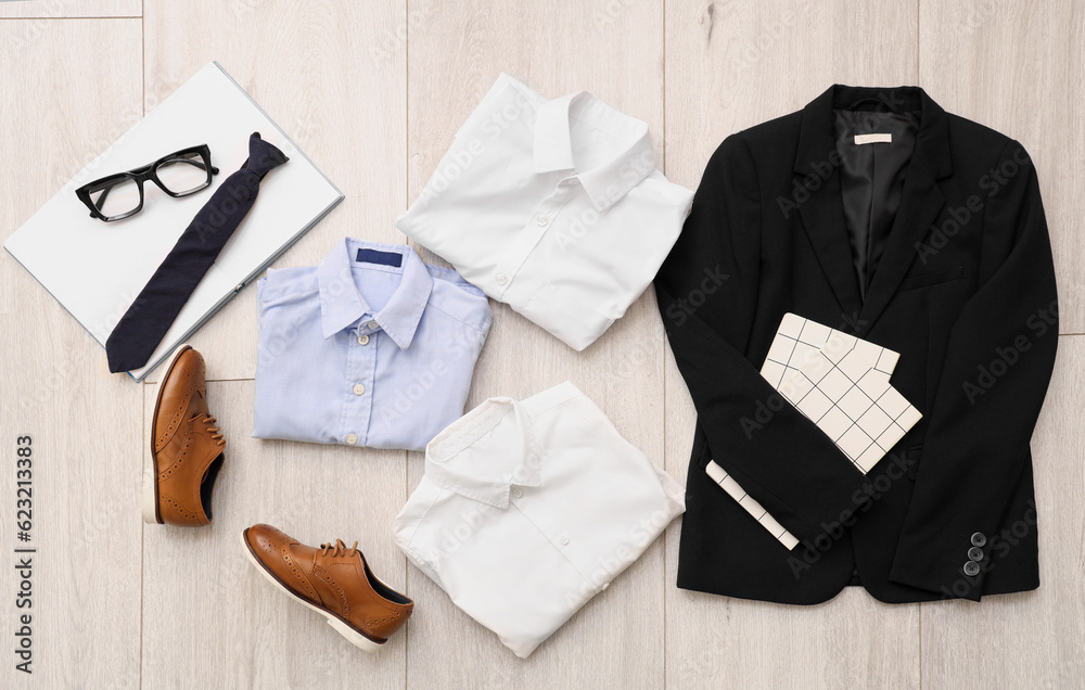 Composition with stylish school uniform, shoes, eyeglasses and tie on wooden background