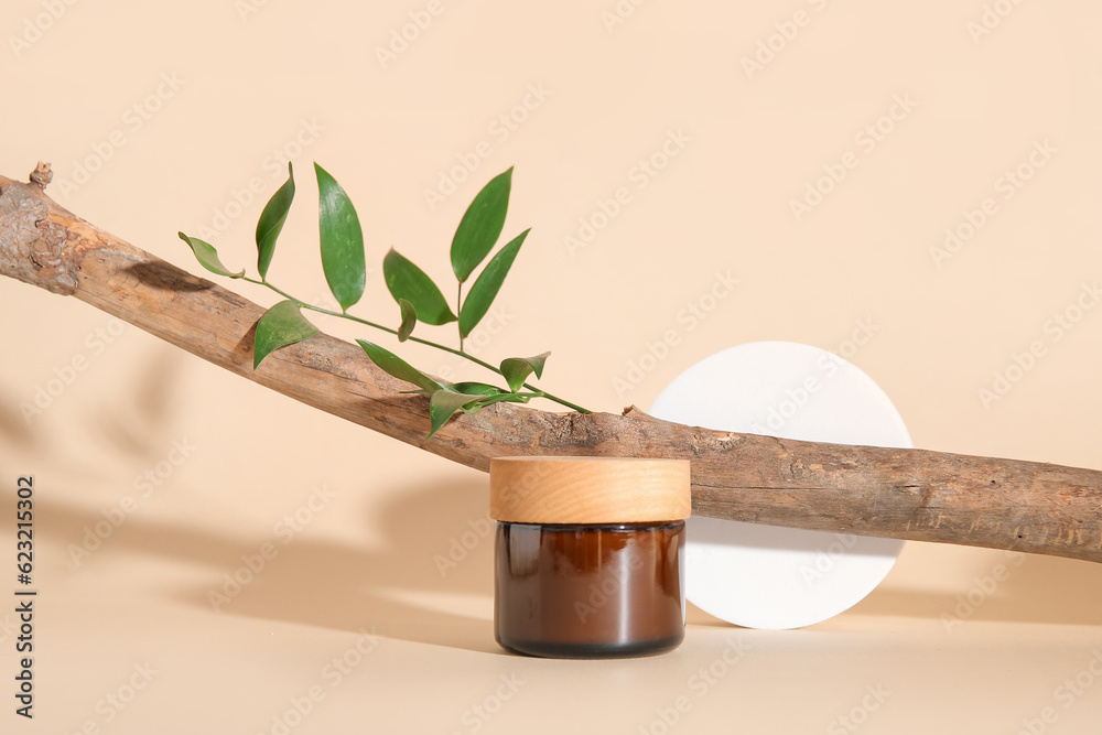 Jar of cosmetic product, tree branch, plaster podium and plant leaf on color background