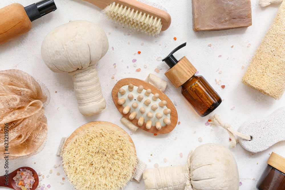 Composition with different bath accessories and cosmetics on light background