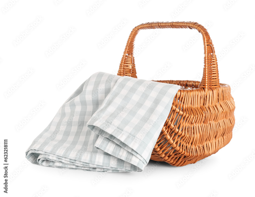 Wicker picnic basket with napkin on white background