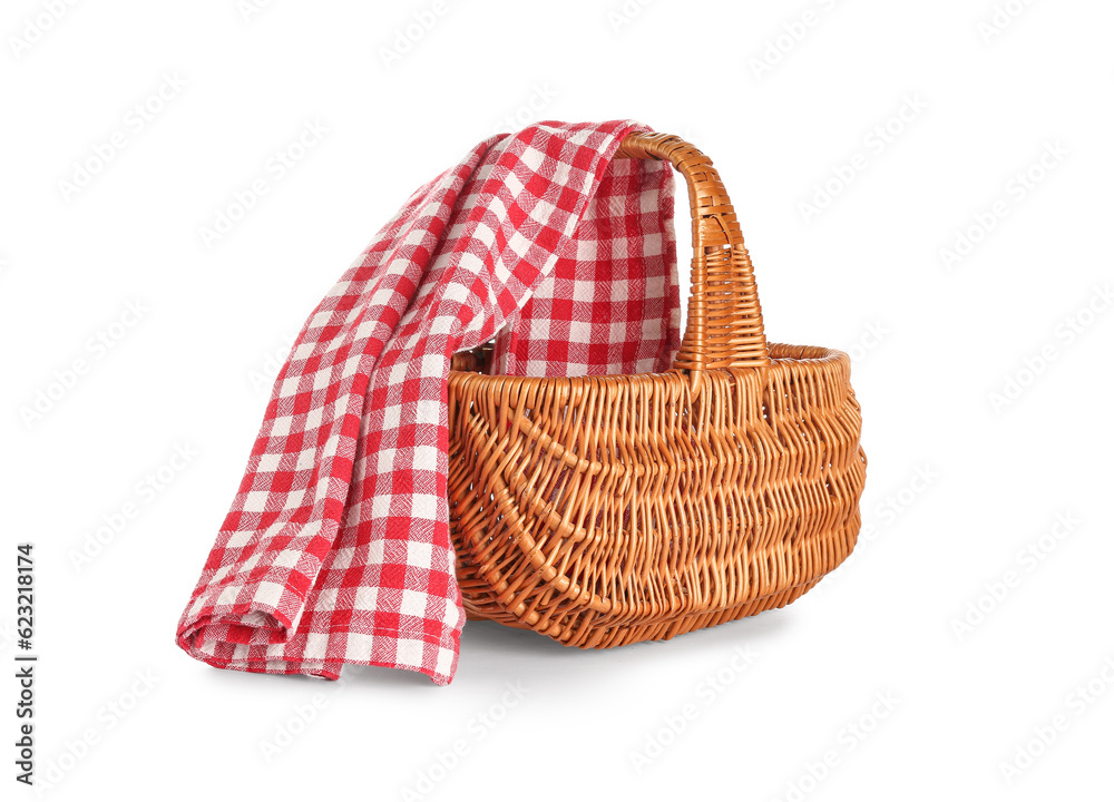 Wicker picnic basket with red checkered napkin isolated on white background