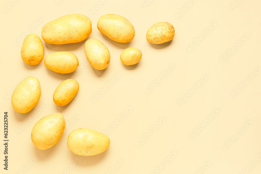 Frame made of raw potatoes on yellow background