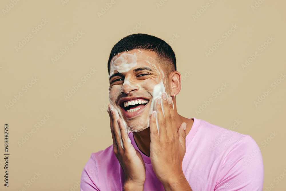 Self-care and grooming, young man applying face wash