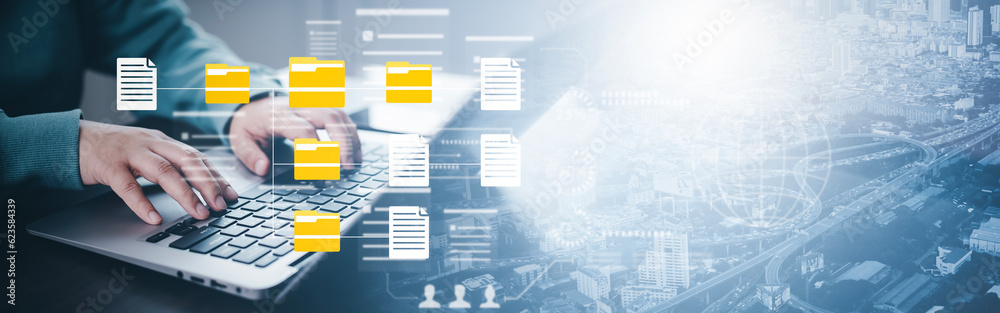 Document Management System DMS, set up by IT consultant working on a digital tablet and laptop compu