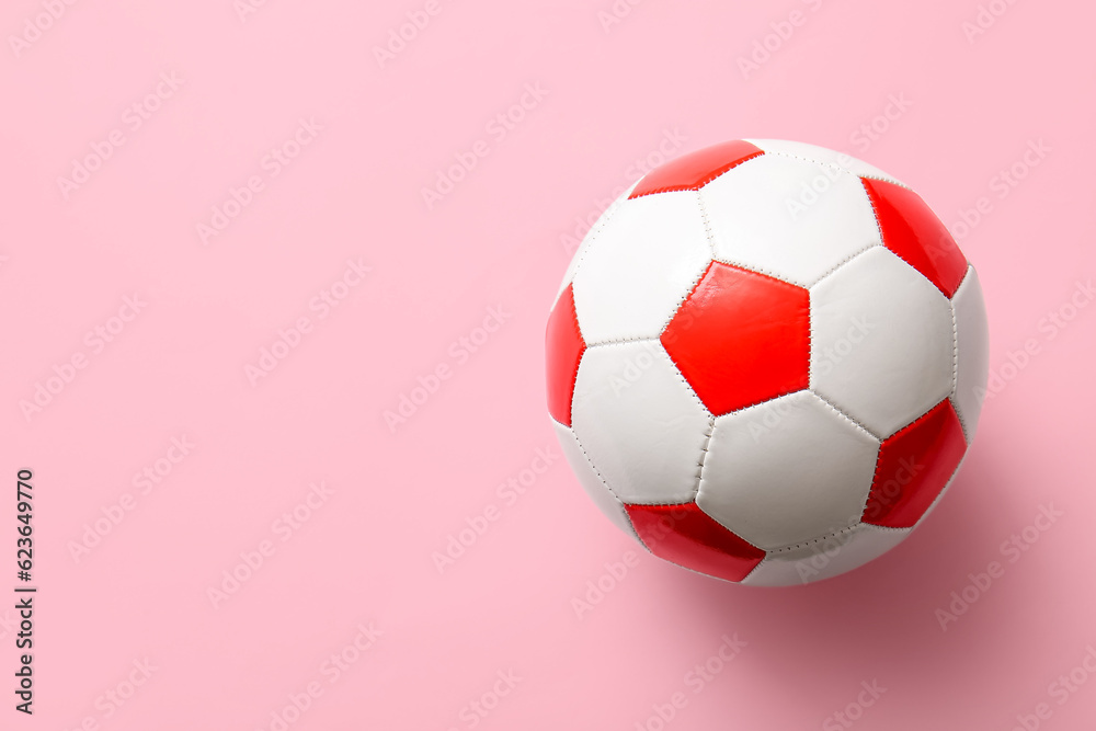 Soccer ball on pink background