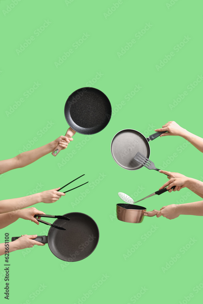 Women with kitchen utensils on green background