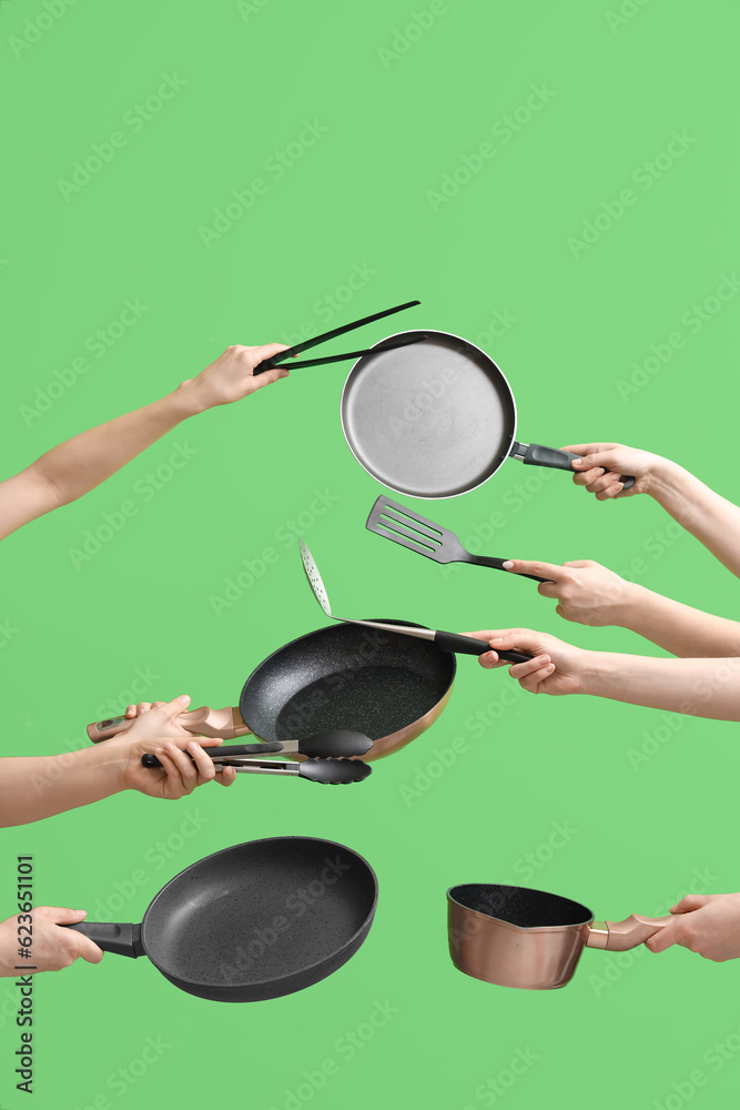 Women with kitchen utensils on green background