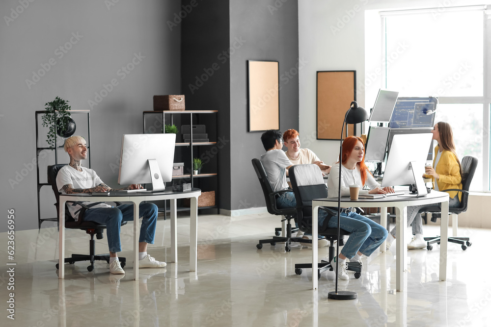 Team of young programmers working in office