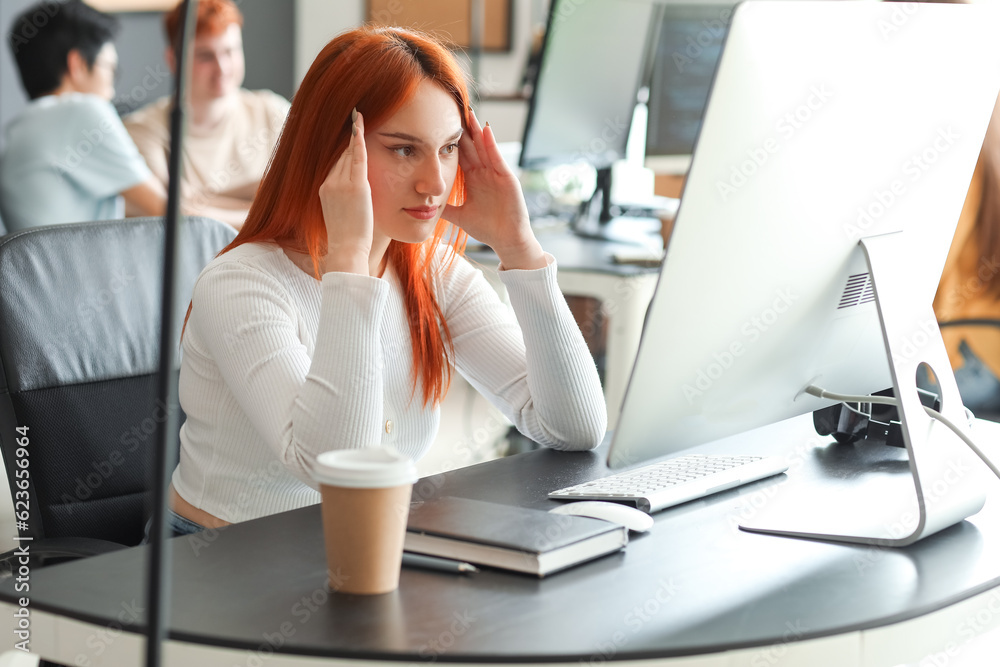 Female programmer working with computer in office