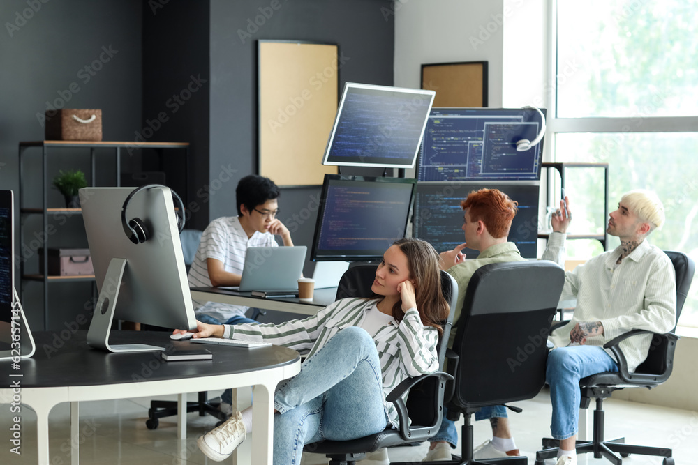 Team of young programmers working in office