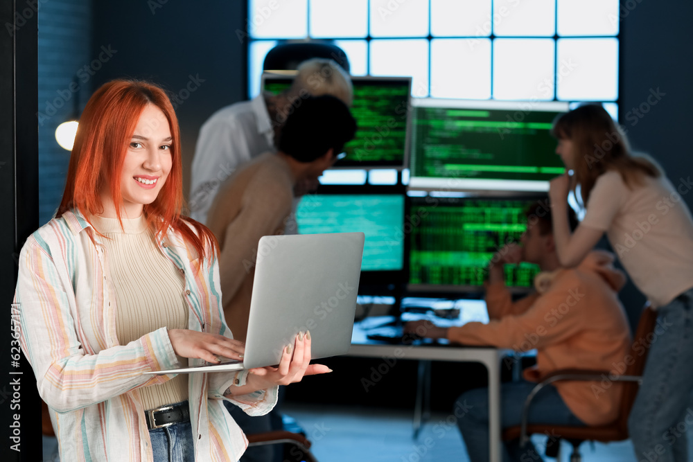 Female programmer working with laptop in office