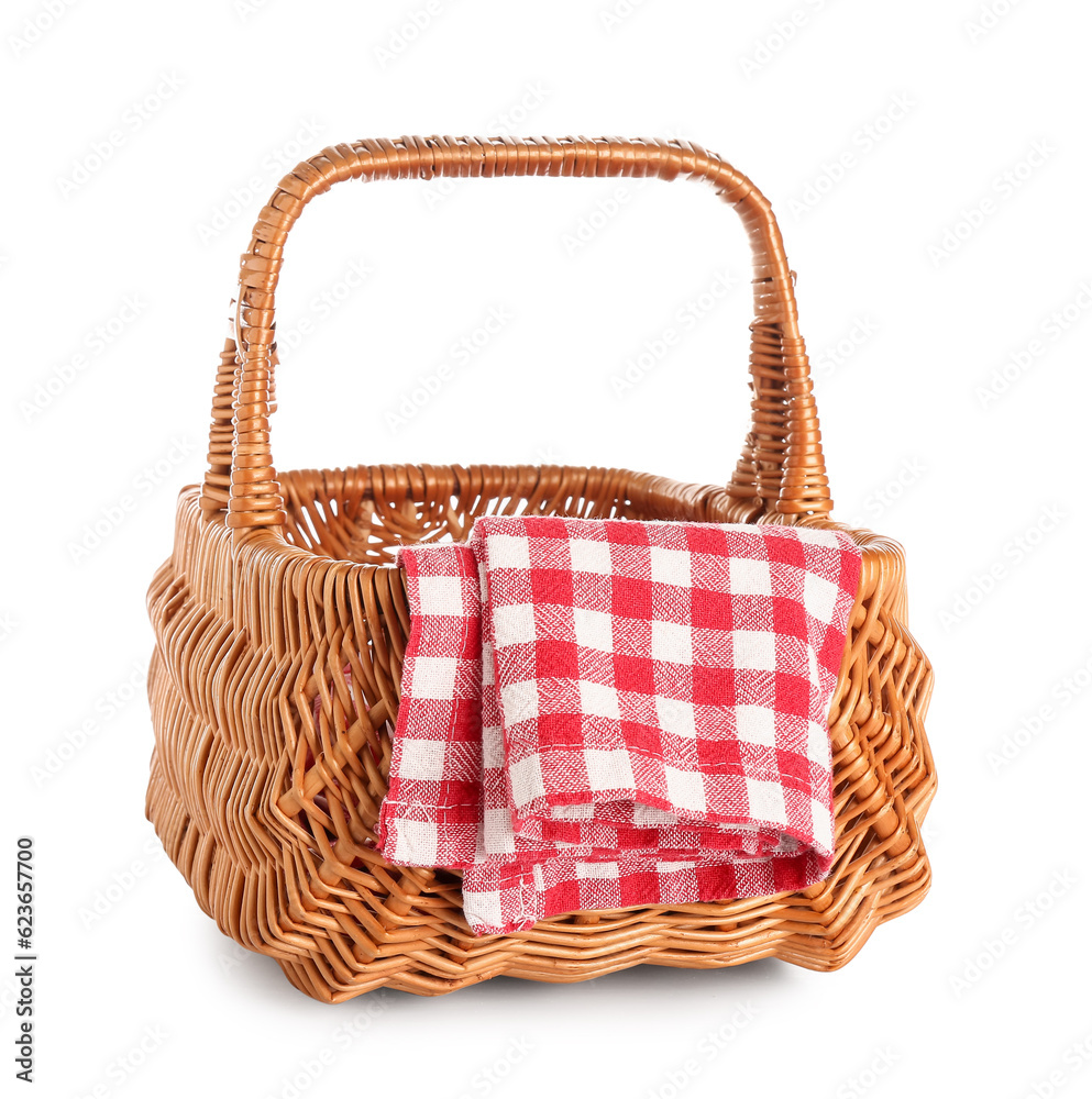 Wicker picnic basket and clean napkin on white background