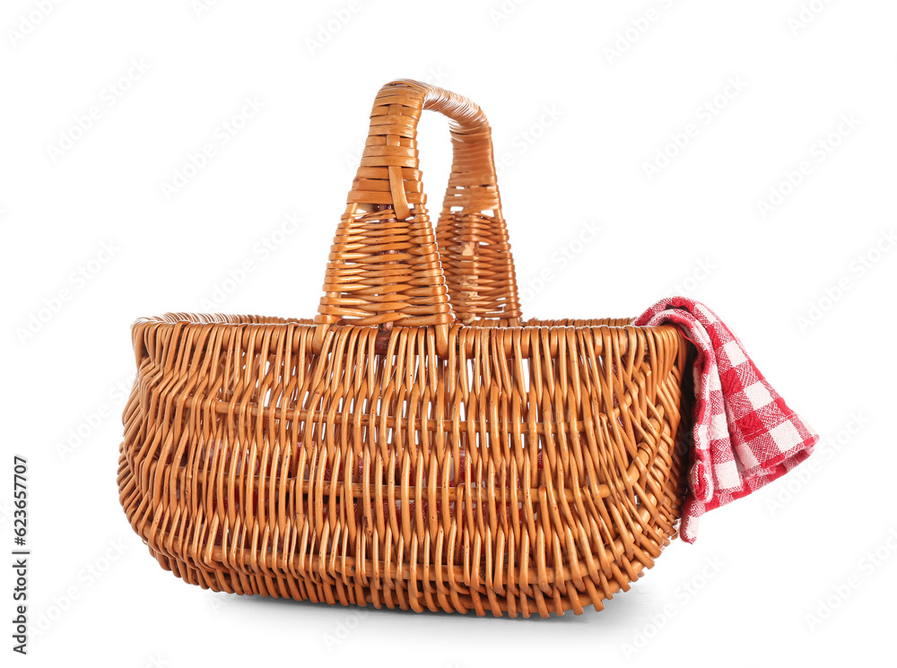 Wicker picnic basket and clean napkin on white background