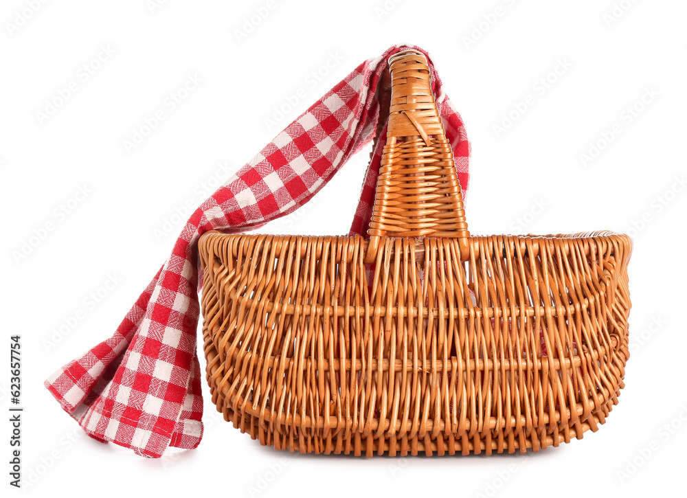 Wicker picnic basket with red checkered napkin isolated on white background