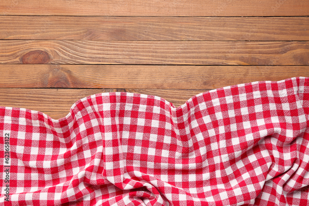 Crumpled red napkin on wooden background, closeup