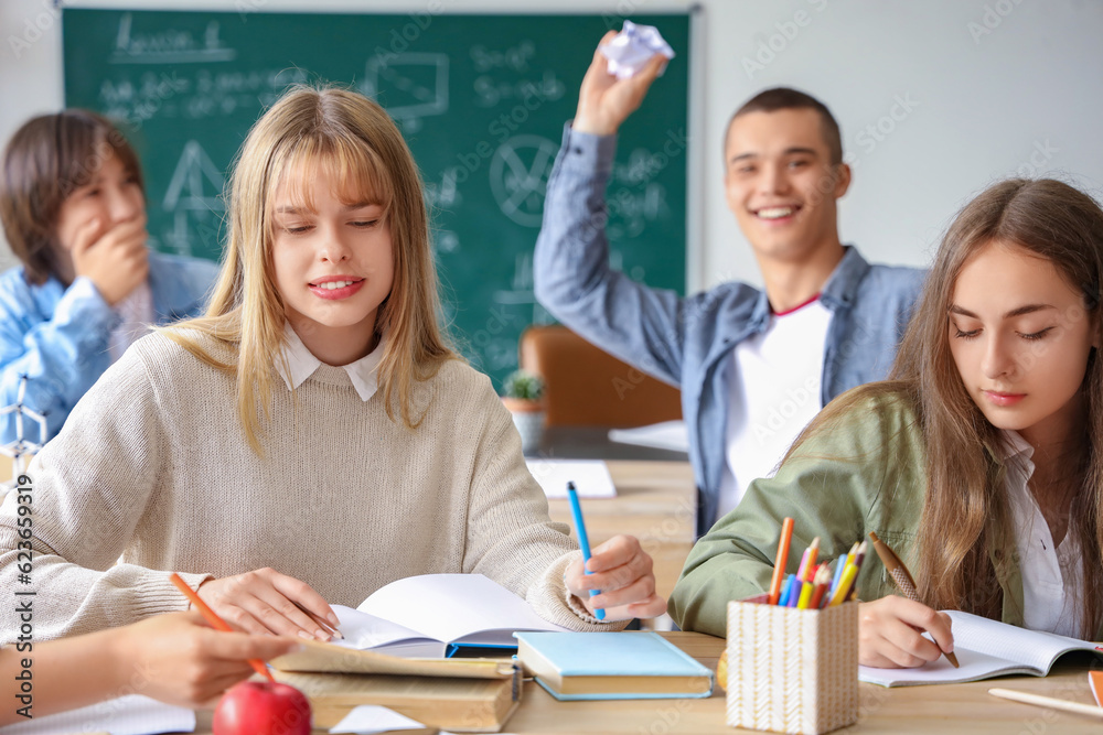 Female students studying at table in classroom