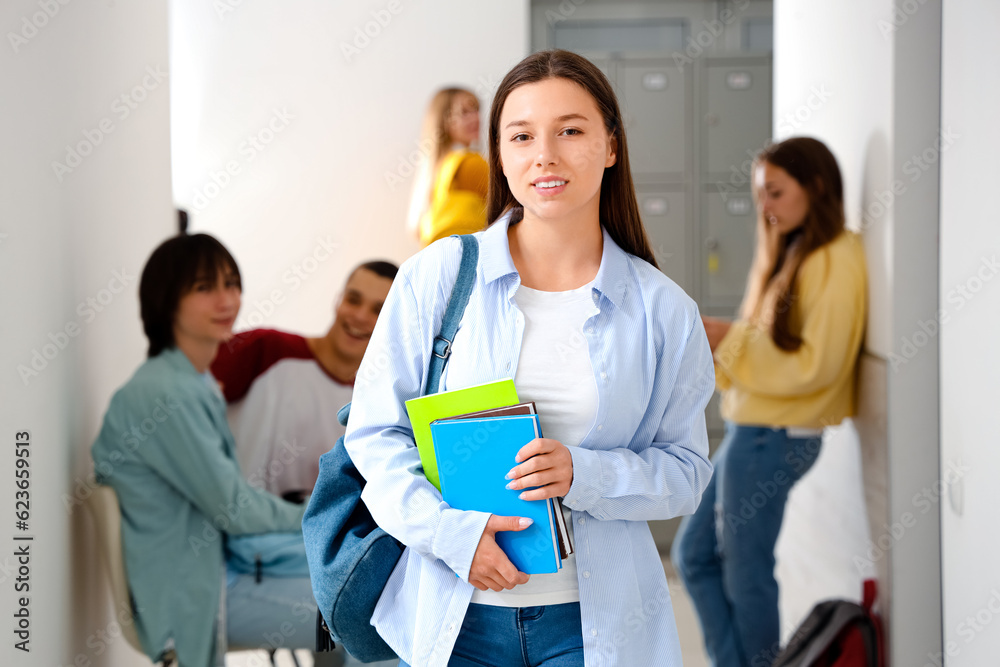 Teenage girl with copybooks at school