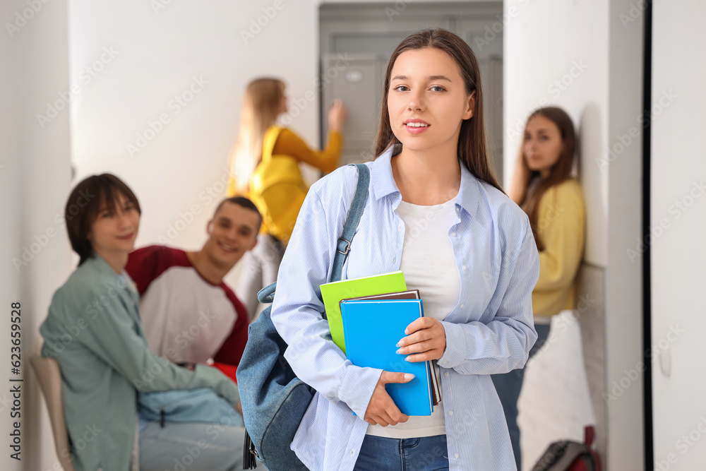 Teenage girl with copybooks at school