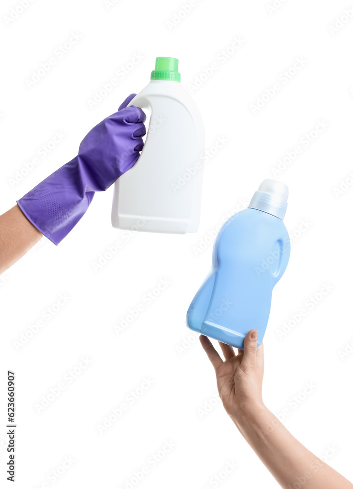 Women with bottles of detergent on white background