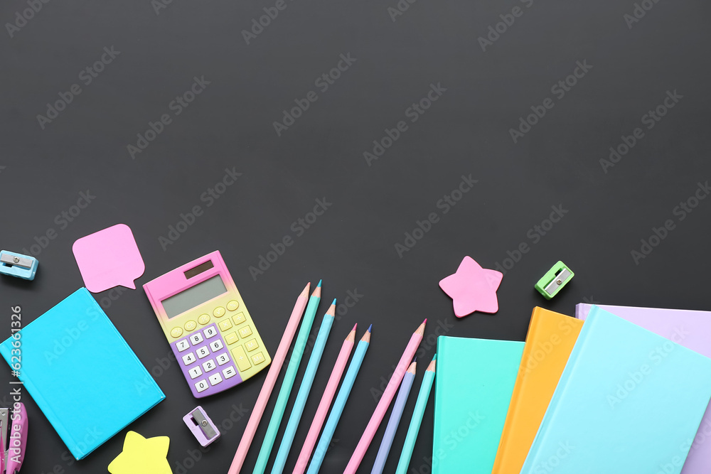 Calculator with different stationery on black chalkboard