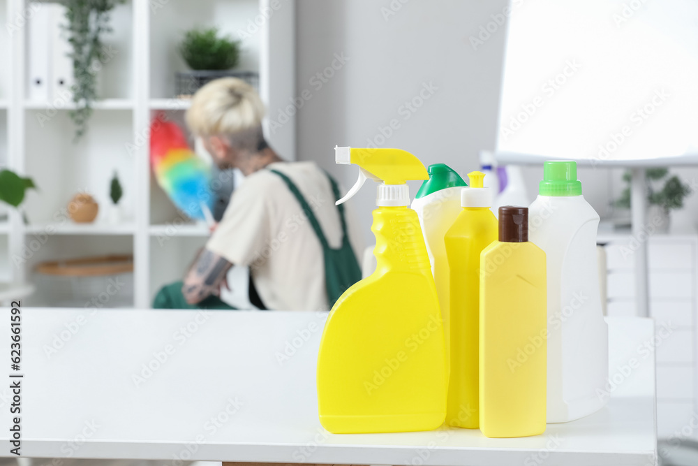 Bottles of detergent on table in office, closeup