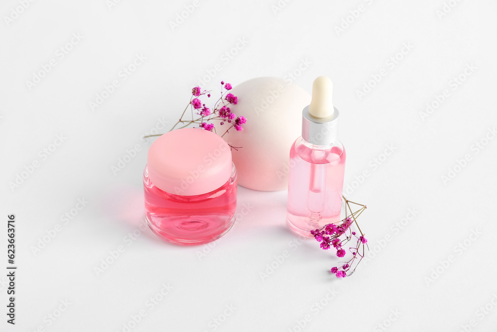 Cosmetic products, plaster decor and gypsophila flowers on light background