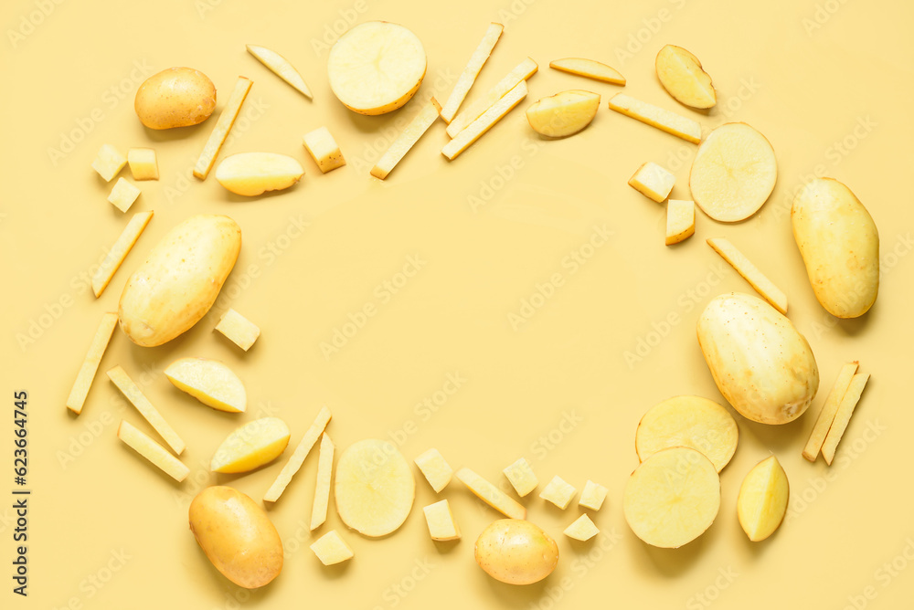 Frame made of raw potatoes on yellow background