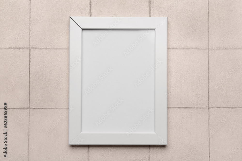 Blank photo frame on white tile background