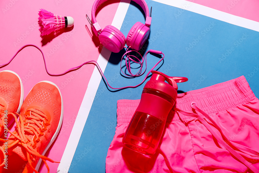 Composition with bottle of water, headphones, clothes and badminton shuttlecock on color background