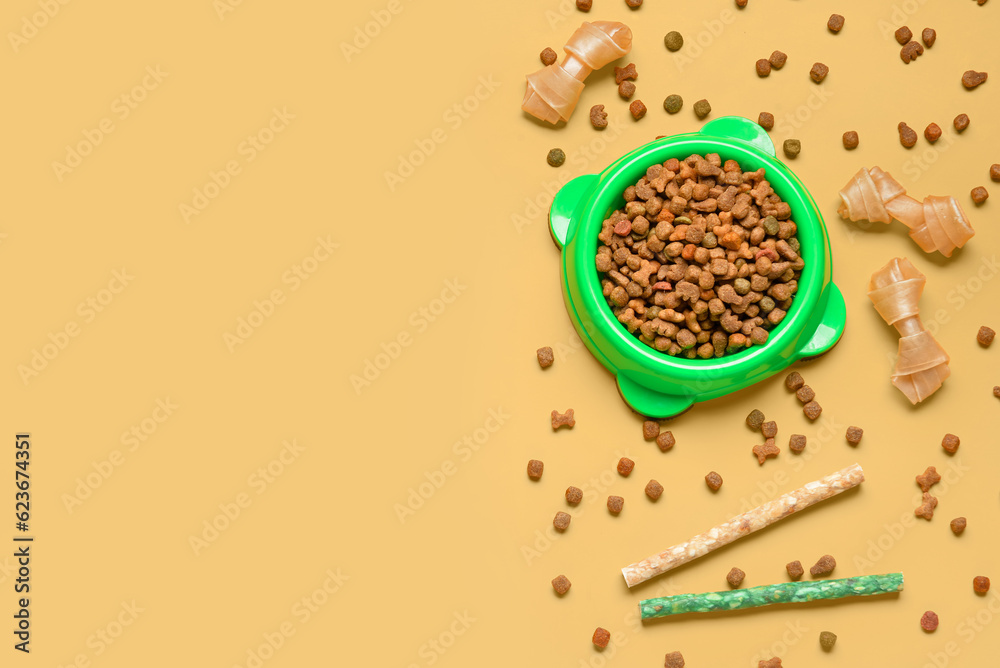 Composition with dry dog food and treats on color background