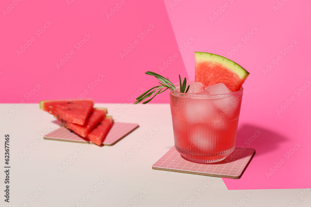 Glass of tasty watermelon cocktail on color background