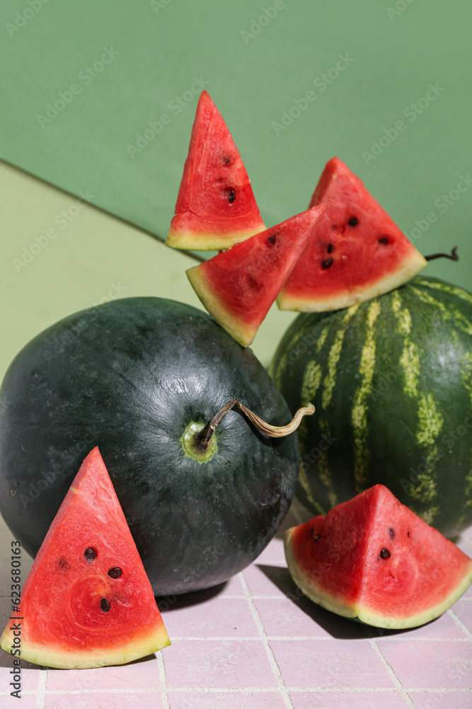 Fresh watermelons on pink tile table