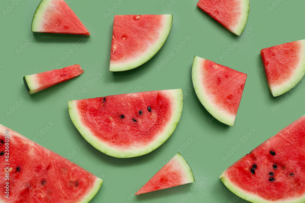 Pieces of fresh watermelon on green background