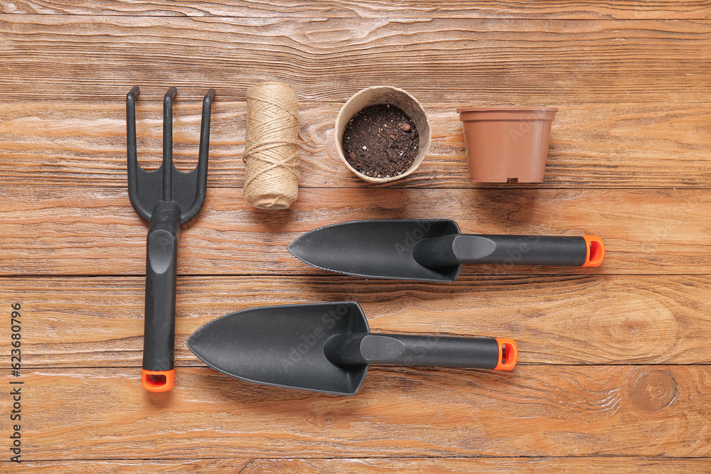 Different gardening tools on wooden background