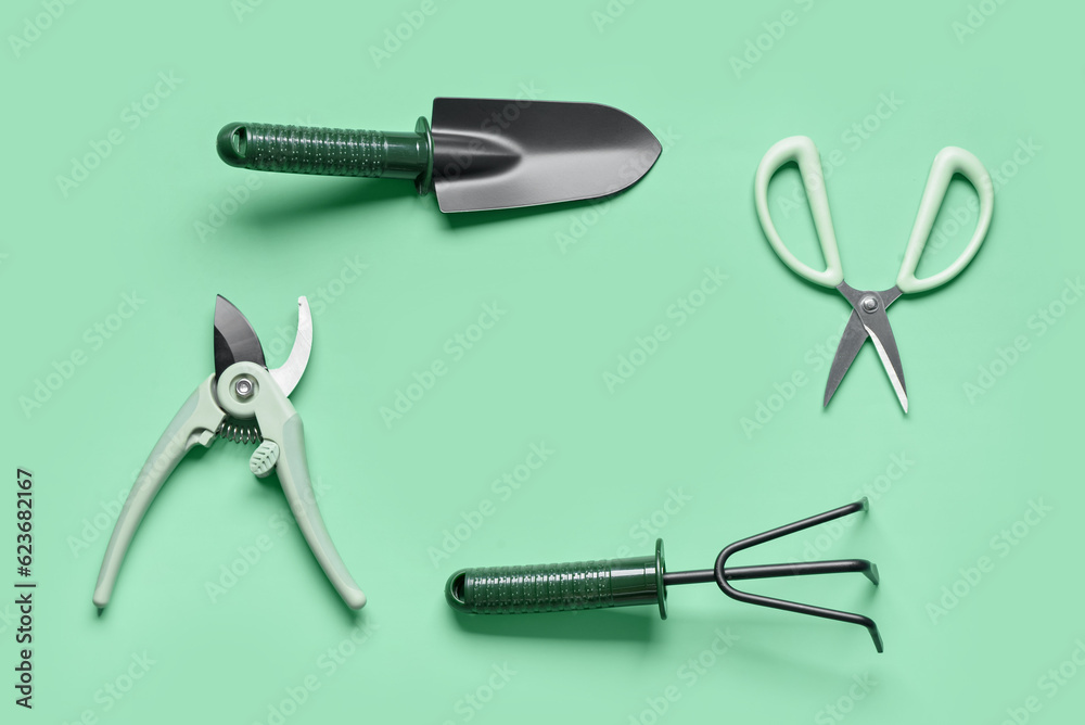 Set of gardening tools on green background