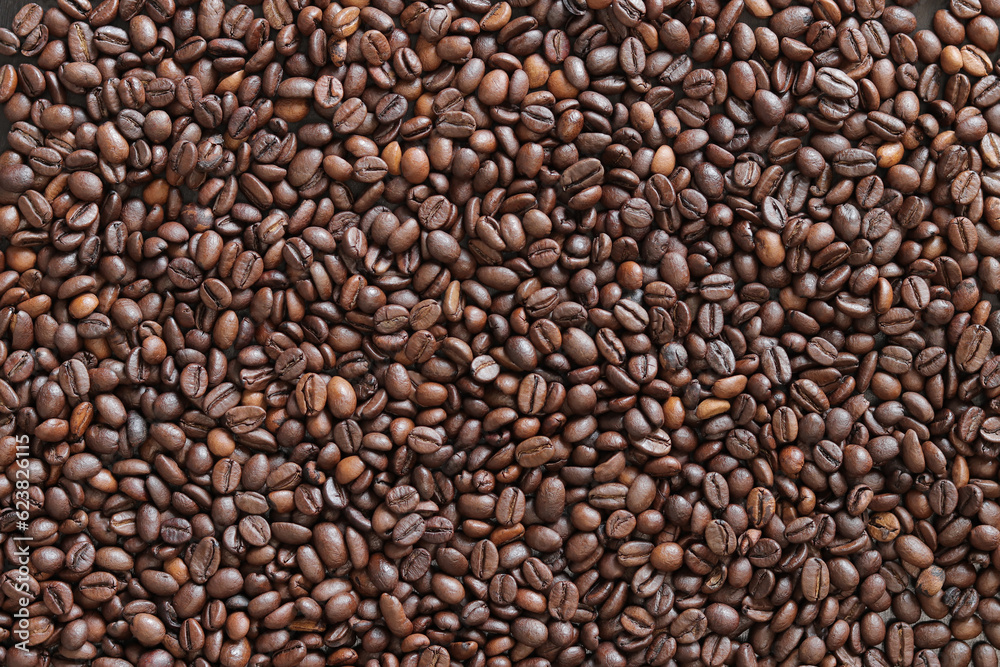 Top view of background representing halves of dark brown coffee beans. Roasted coffee beans, copy sp