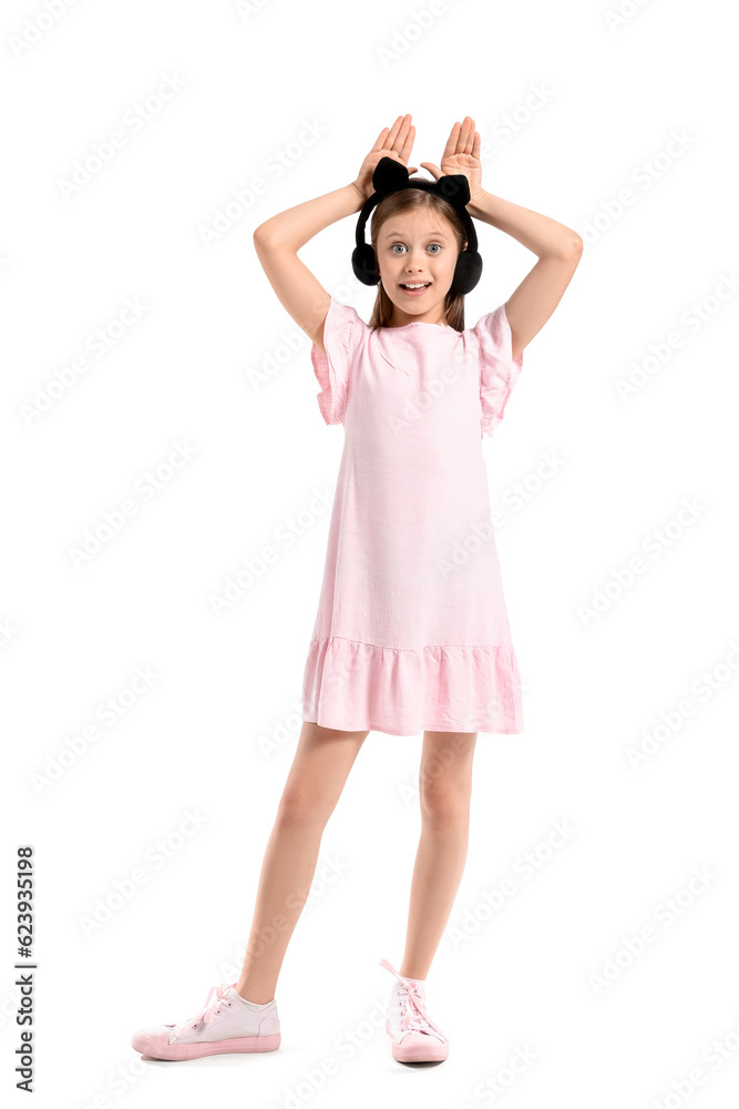 Little girl in cute headphones on white background