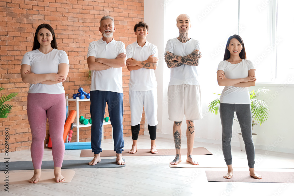 Group of sporty people training in gym