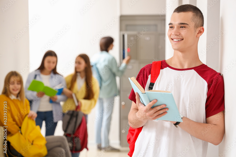 Teenage boy reading book at school