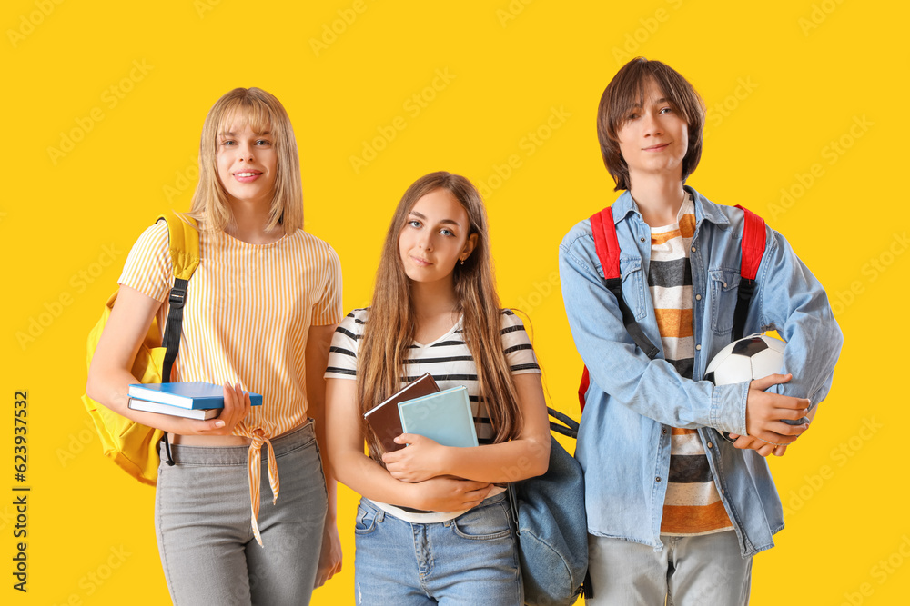 Teenage students on yellow background